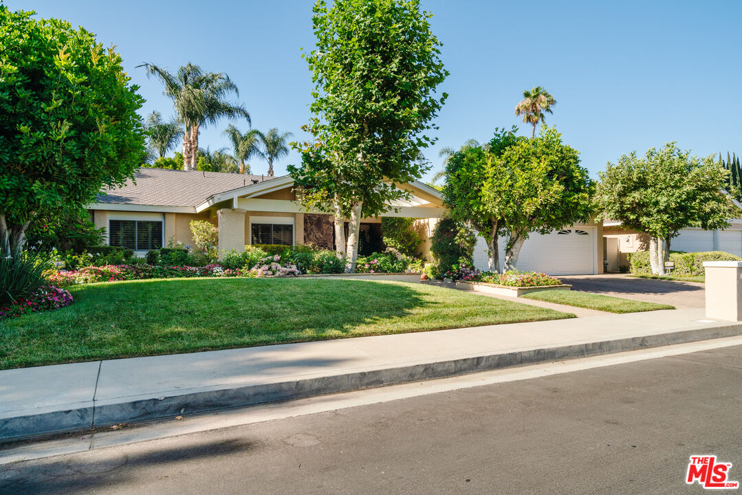 17835 Lemarsh Street Northridge, CA 91325 - Photo 5 of 41 a front view of a house with a yard and potted plants