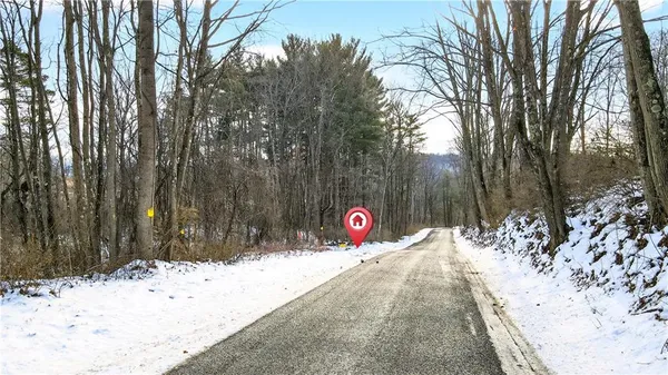 a view of a wooden fence next to a road