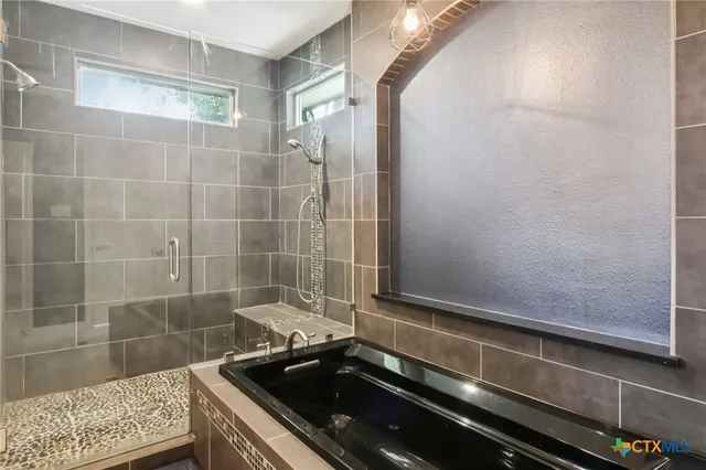 a bathroom with a granite countertop sink a toilet and shower