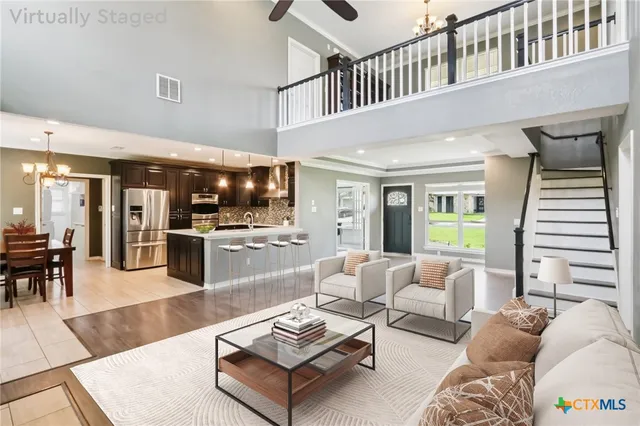 a living room with furniture and kitchen view