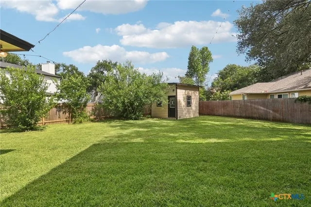 a backyard of a house with lots of green space