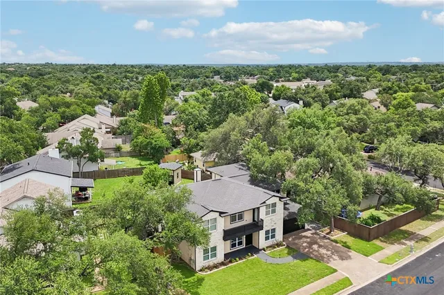 an aerial view of a house with garden space and street view