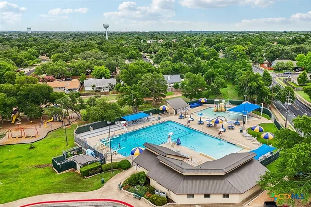 an aerial view of a residential houses with outdoor space and garden
