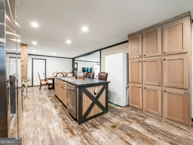 a view of kitchen with furniture and refrigerator