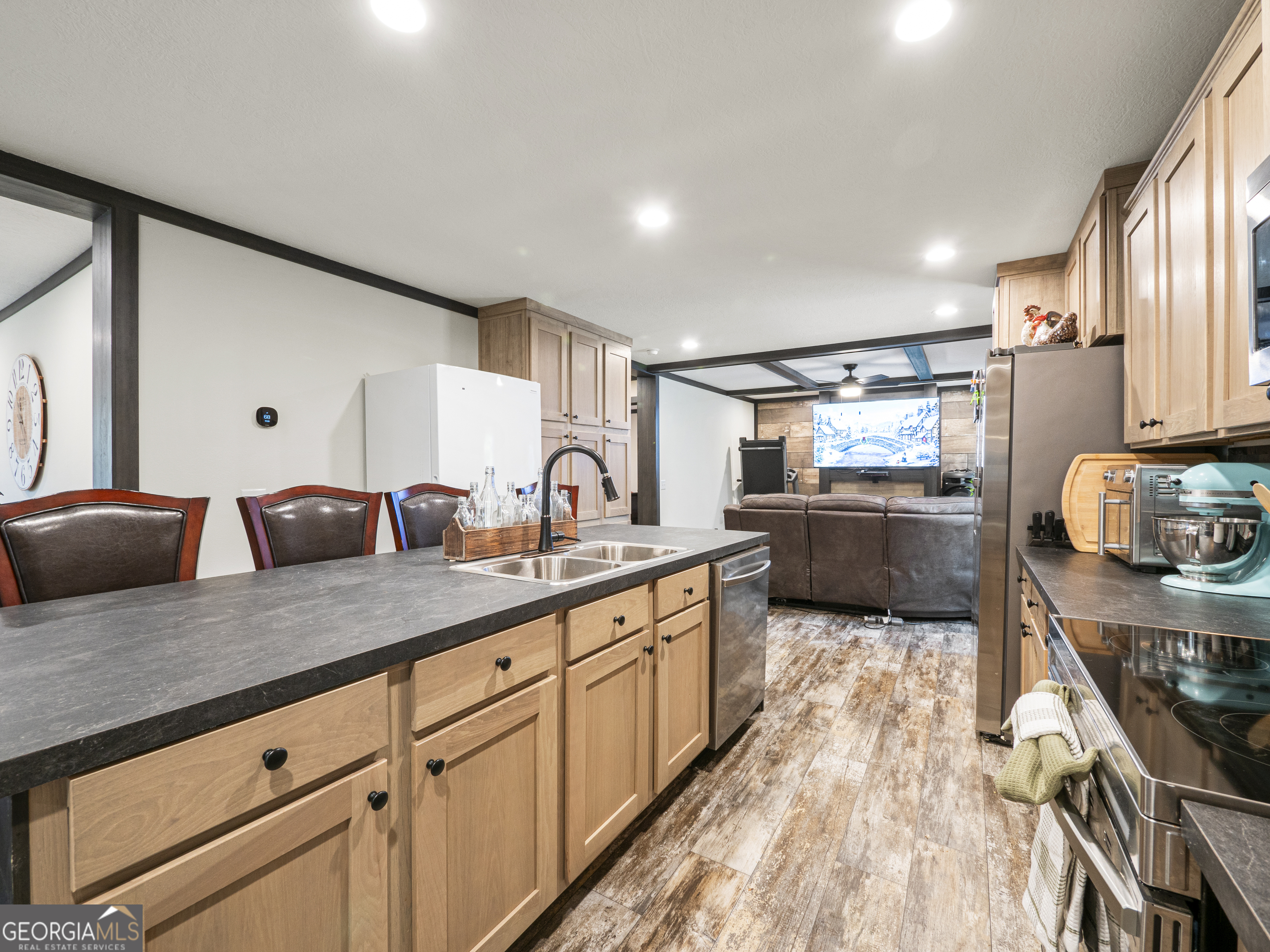 163 M M T Trail Commerce, GA 30530 - Photo 15 of 32 a large kitchen with stainless steel appliances granite countertop a lot of counter space and wooden floors