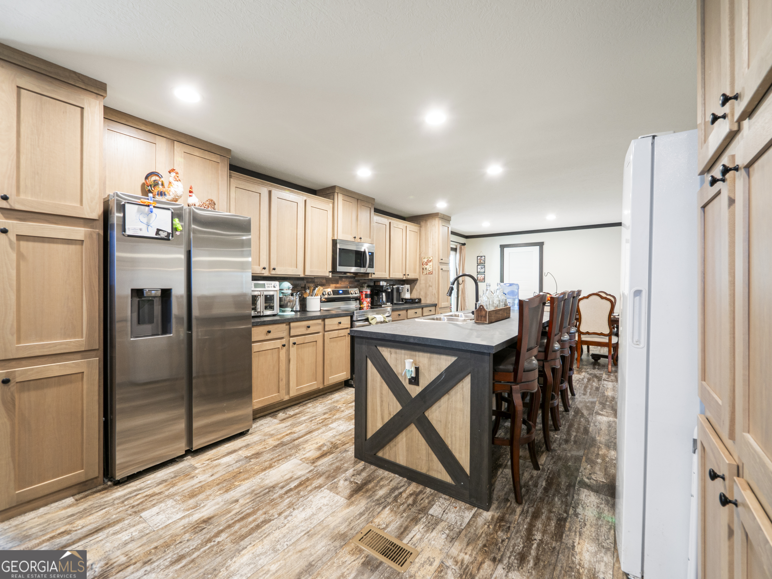 163 M M T Trail Commerce, GA 30530 - Photo 16 of 32 a kitchen with stainless steel appliances kitchen island granite countertop a refrigerator a stove a sink a table and chairs