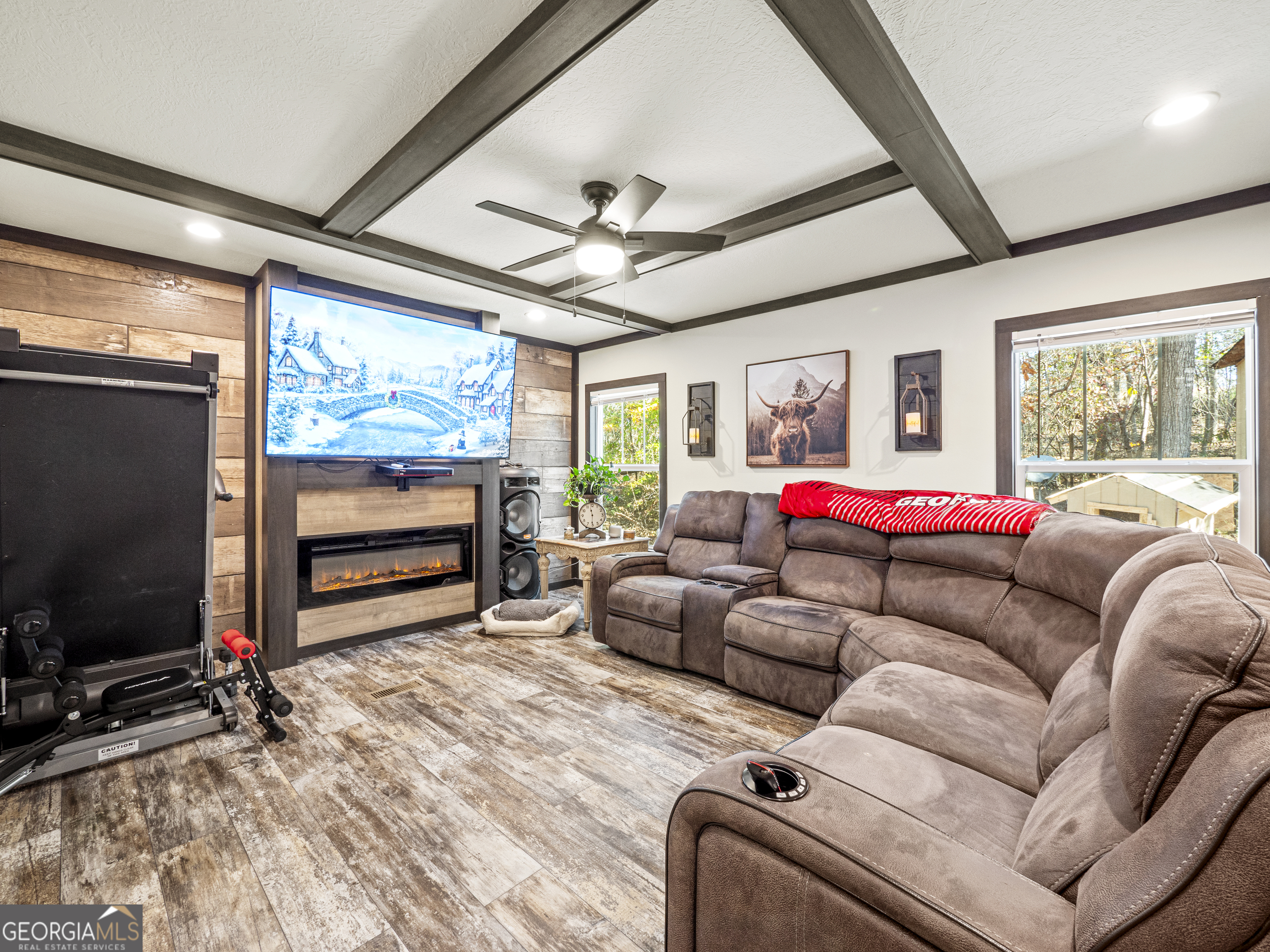 163 M M T Trail Commerce, GA 30530 - Photo 17 of 32 a living room with furniture a flat screen tv and a large window