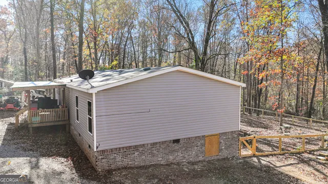 a backyard of a house with a table and chairs