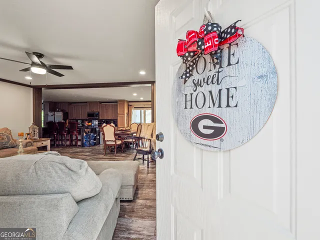a living room with furniture and a chandelier