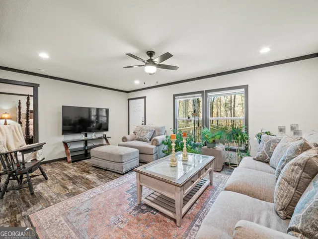 a living room with furniture and a flat screen tv