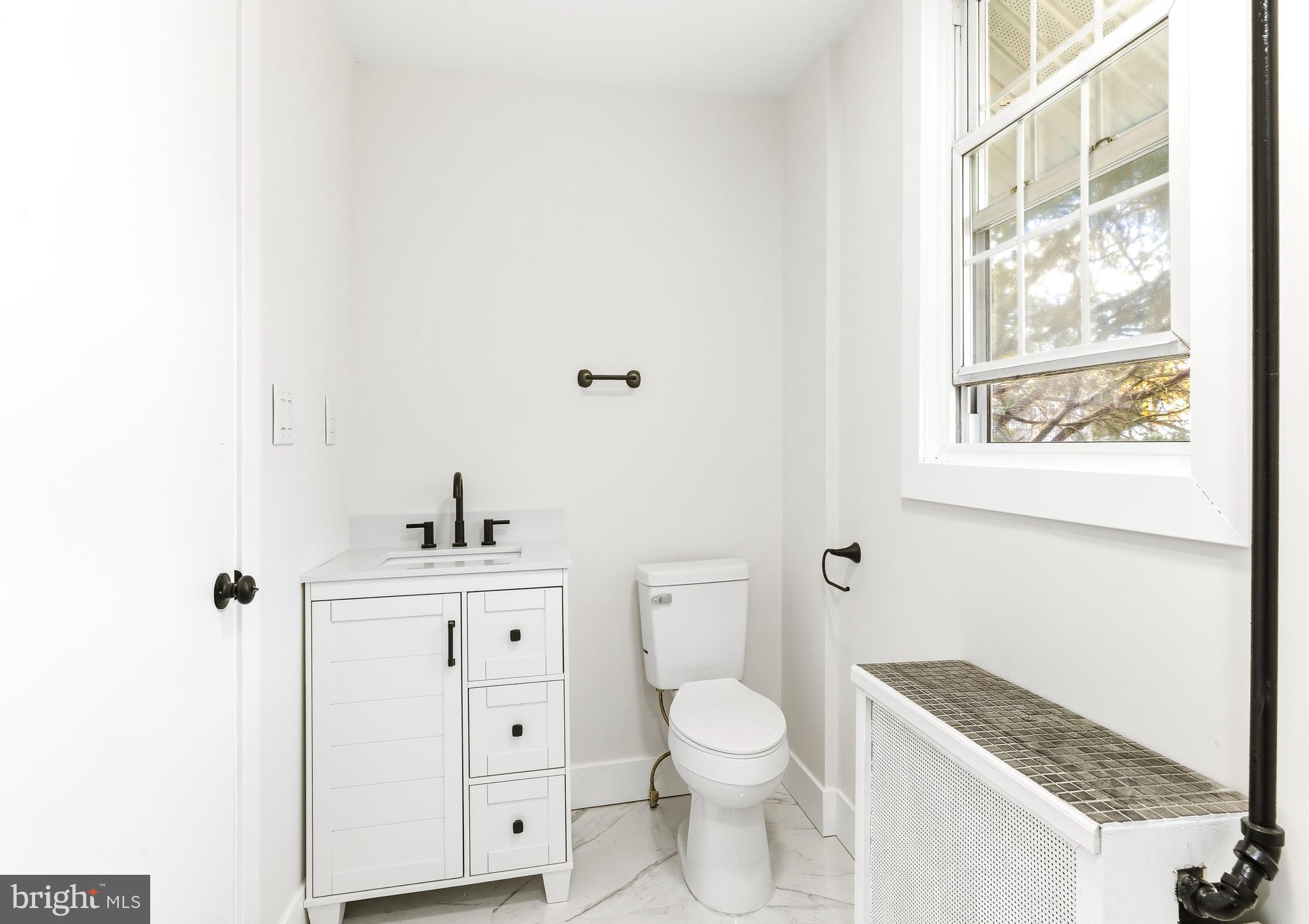 110 East Seaview Avenue Linwood, NJ 08221 - Photo 26 of 48 a white toilet sitting next to a bathroom sink