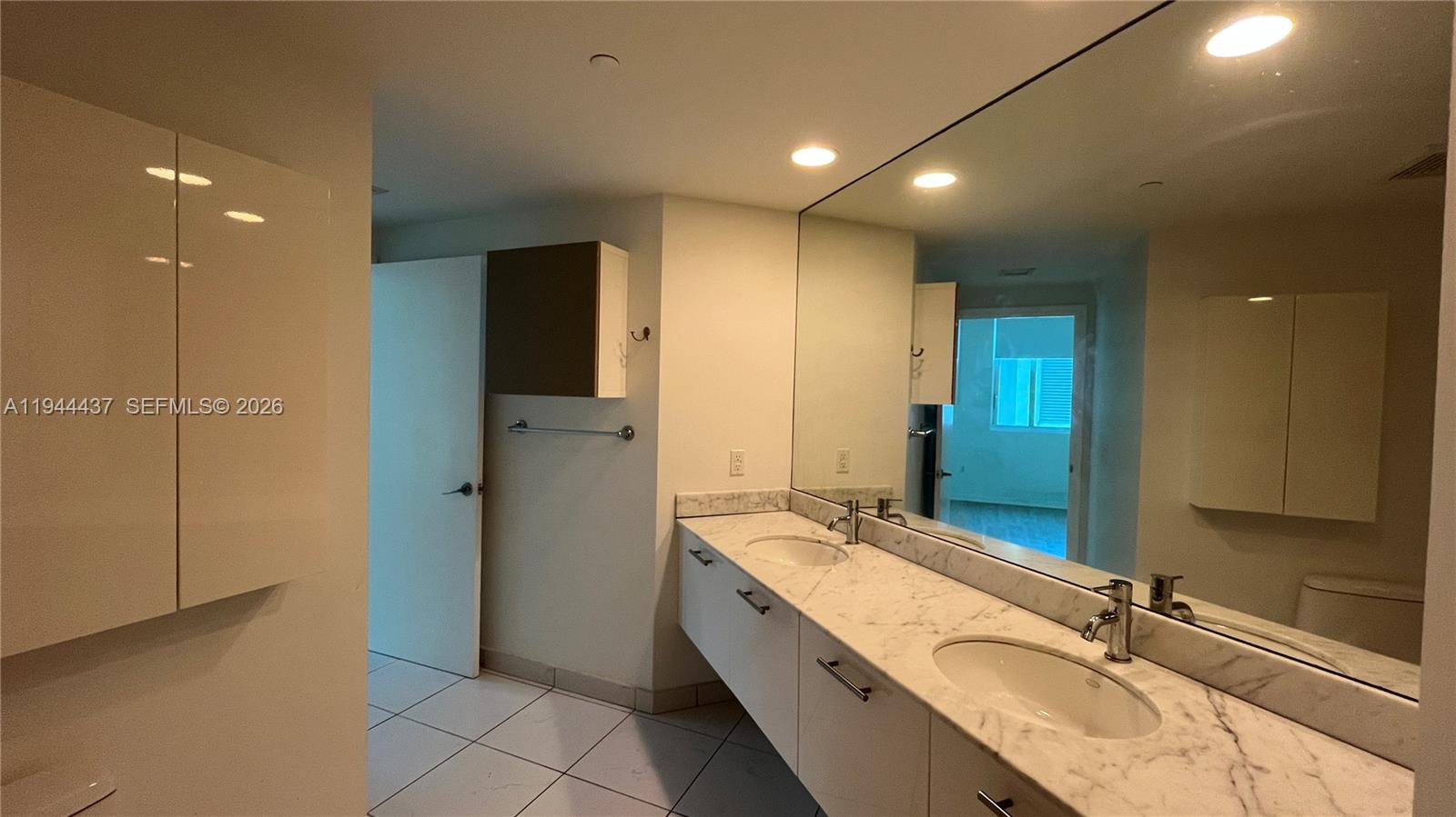 55 Southeast 6th Street, Unit 2601 Miami, FL 33131 - Photo 23 of 46 a bathroom with a granite countertop sink mirror and double