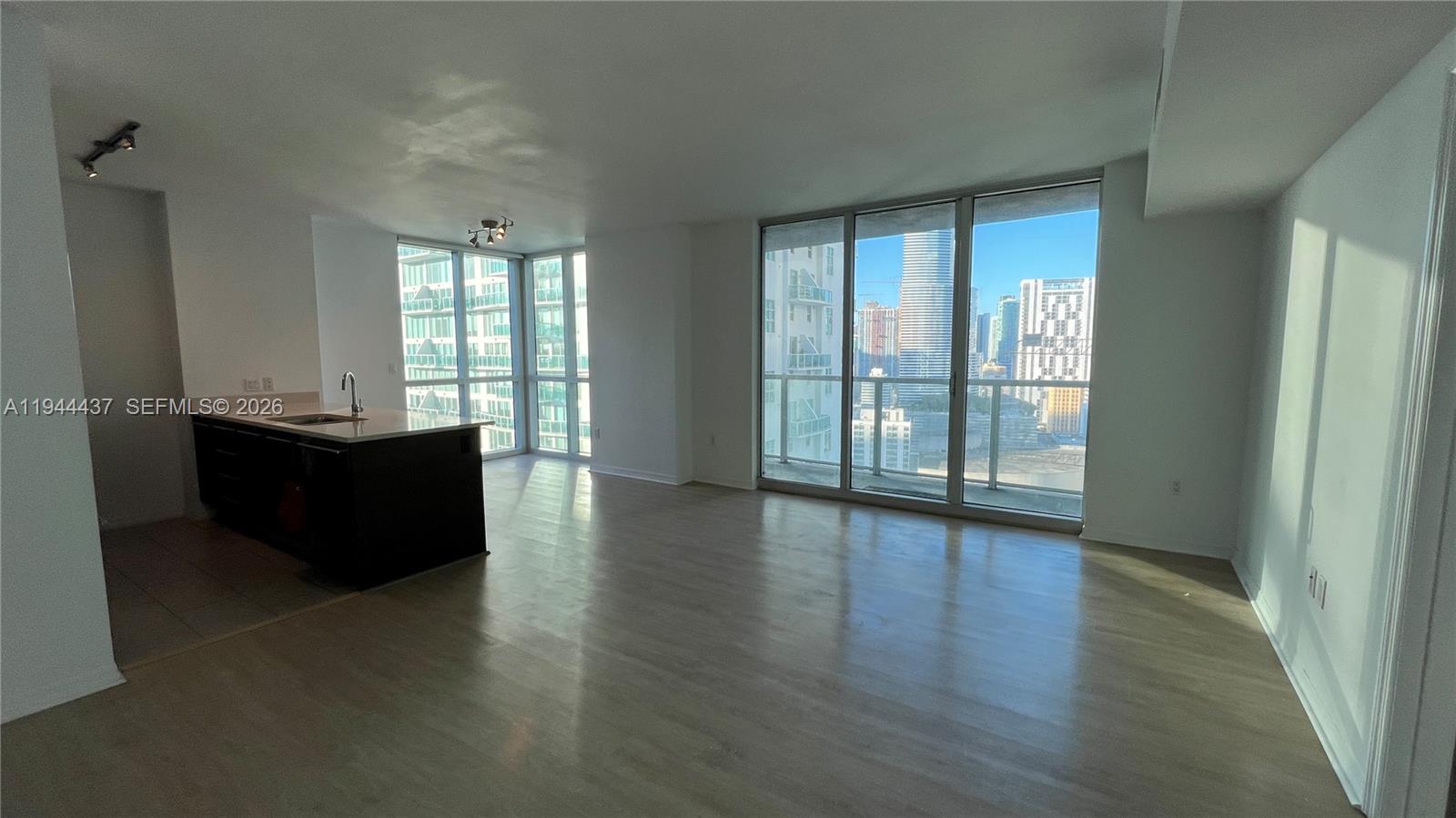 55 Southeast 6th Street, Unit 2601 Miami, FL 33131 - Photo 3 of 46 wooden floor in an empty room with a window
