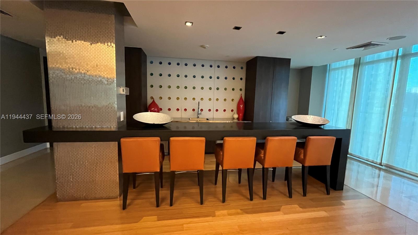 55 Southeast 6th Street, Unit 2601 Miami, FL 33131 - Photo 32 of 46 a view of a dining room with furniture and wooden floor