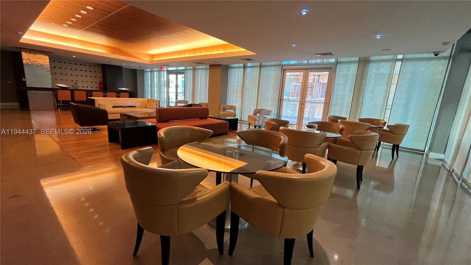 55 Southeast 6th Street, Unit 2601 Miami, FL 33131 - Photo 33 of 46 a living room with furniture a fireplace and a dining table