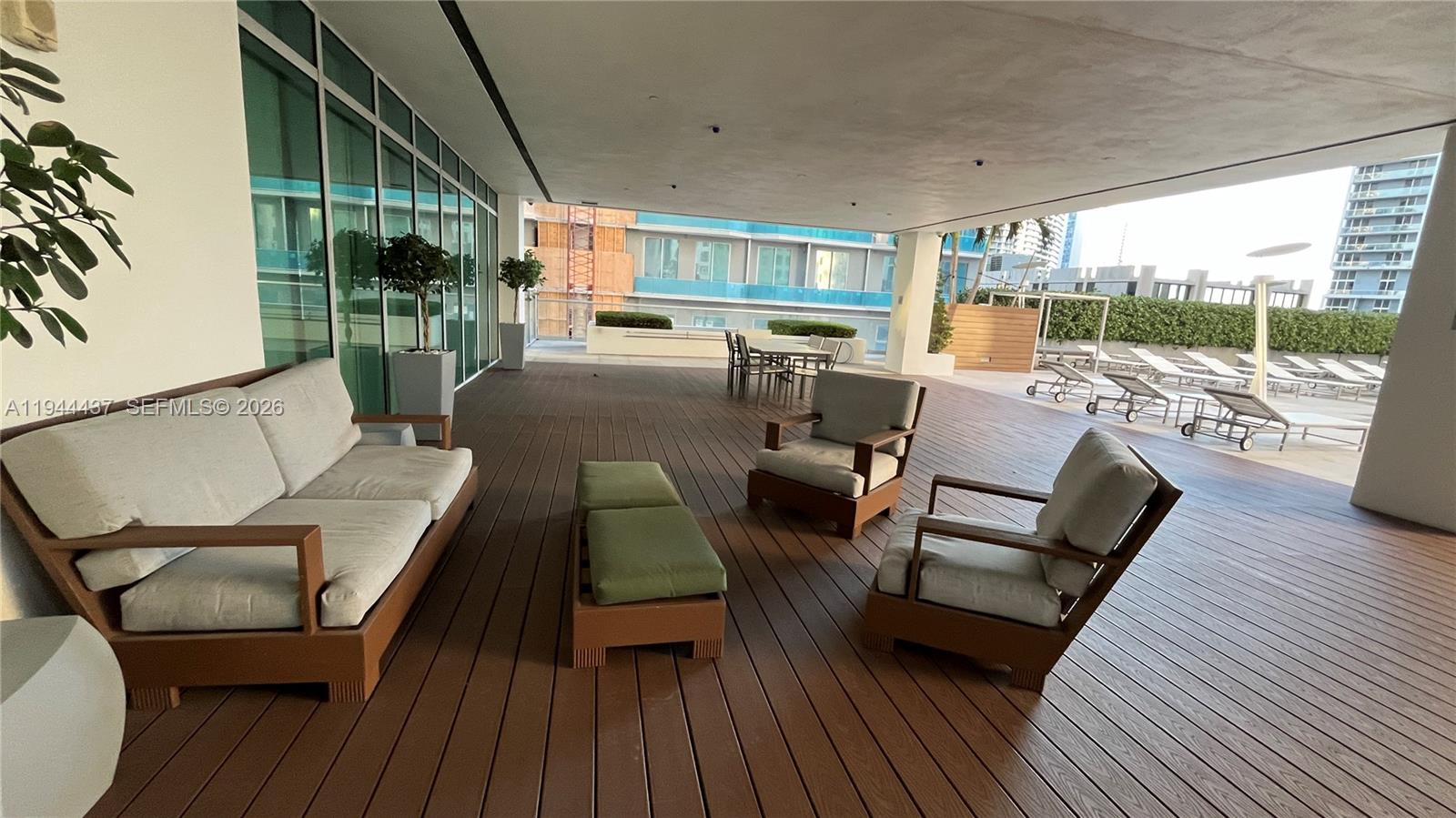 55 Southeast 6th Street, Unit 2601 Miami, FL 33131 - Photo 34 of 46 a outdoor living space with furniture and wooden floor