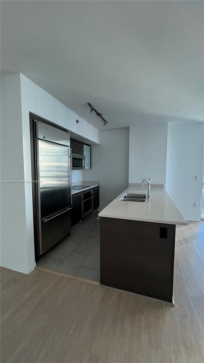 55 Southeast 6th Street, Unit 2601 Miami, FL 33131 - Photo 8 of 46 a kitchen with stainless steel appliances a stove and a refrigerator