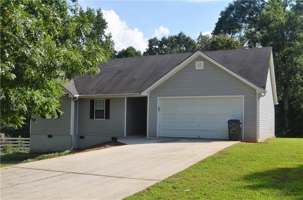 220 Mountain Ridge Covington, GA 30016 - Photo 1 of 1 a front view of a house with a yard and garage