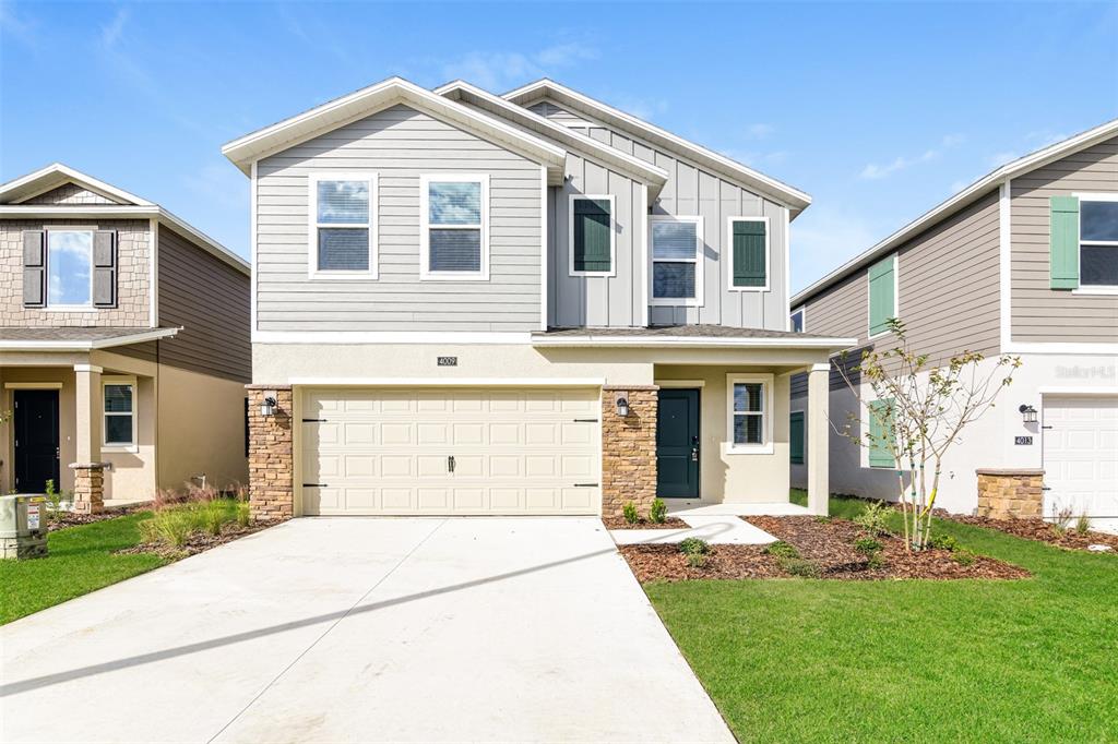 4009 Old Ml Road Haines City, FL 33844 - Photo 1 of 24 a front view of a house with a yard and garage