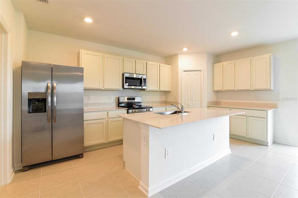 4009 Old Ml Road Haines City, FL 33844 - Photo 13 of 24 a kitchen with kitchen island a counter top space stainless steel appliances and cabinets