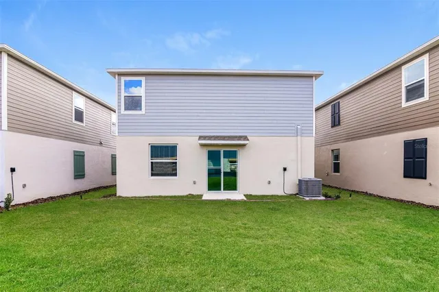 a view of a backyard with potted plants and large tree