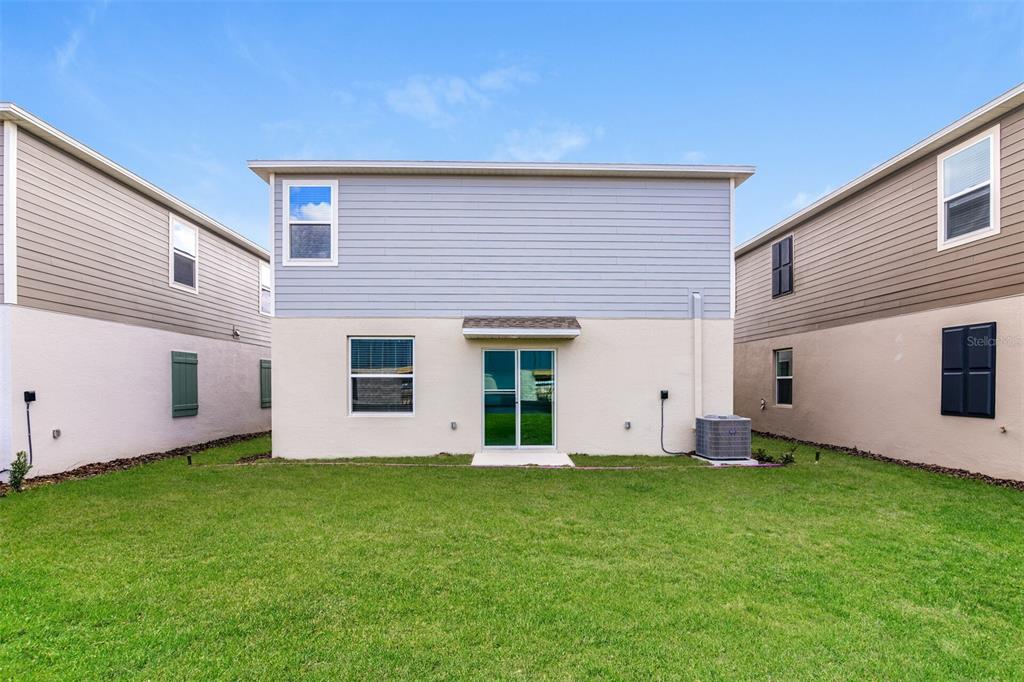 4009 Old Ml Road Haines City, FL 33844 - Photo 23 of 24 a view of a backyard with potted plants and large tree