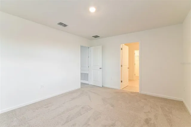 an empty room with a empty space and windows