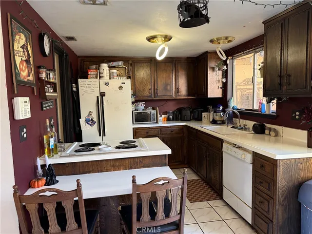 a kitchen with a stove a refrigerator and a dining table