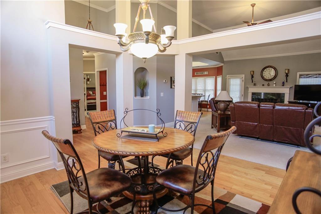 3875 Spring Manor Court Loganville, GA 30052 - Photo 14 of 23 a view of a dining room with furniture and a chandelier