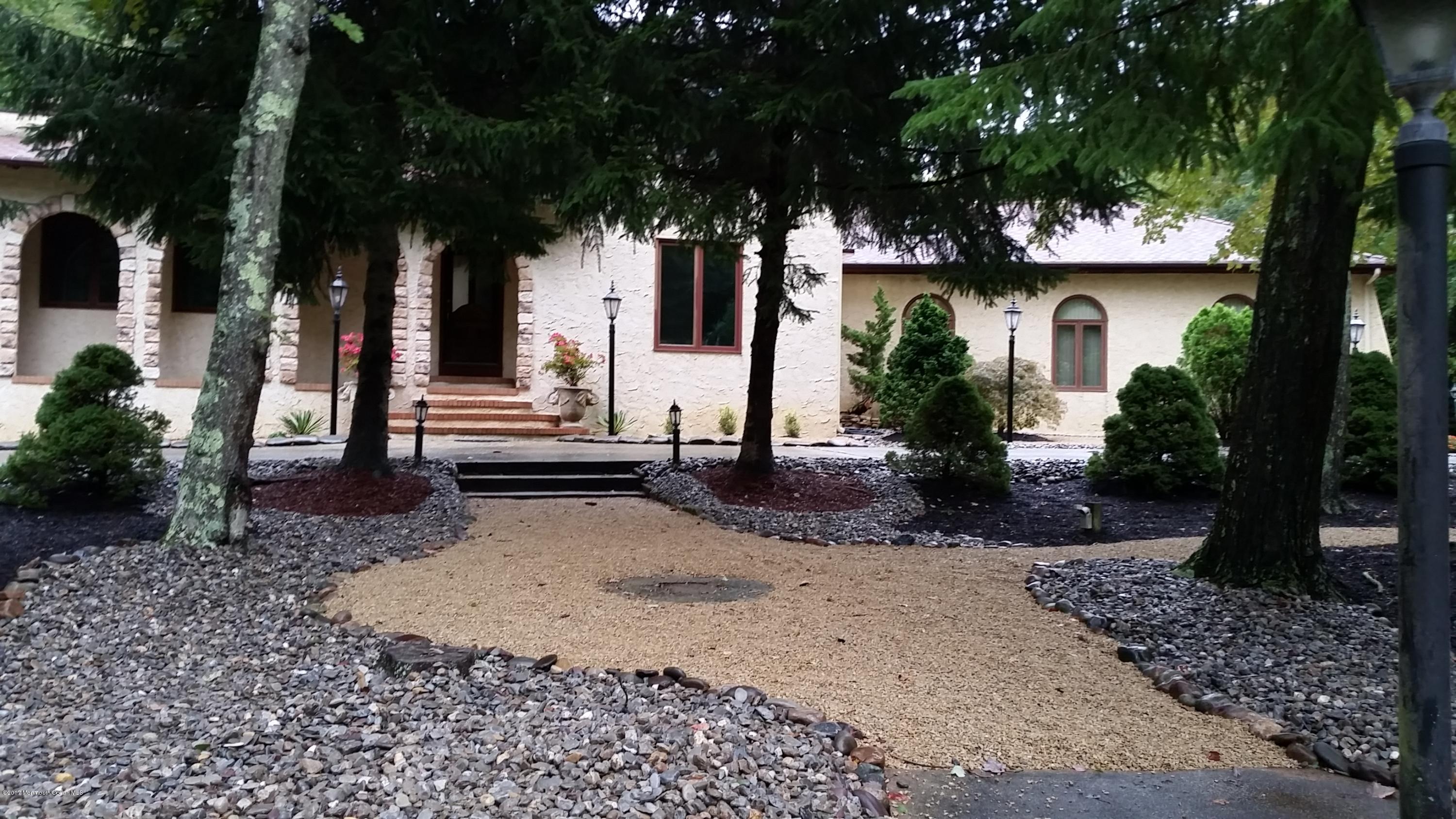 front view of a house with a tree in front