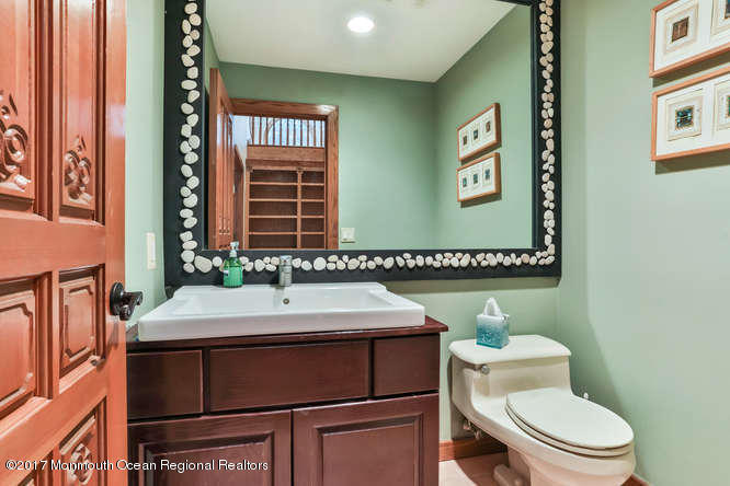 1644 Martin Road Neptune, NJ 07753 - Photo 19 of 42 a bathroom with a sink a toilet and mirror