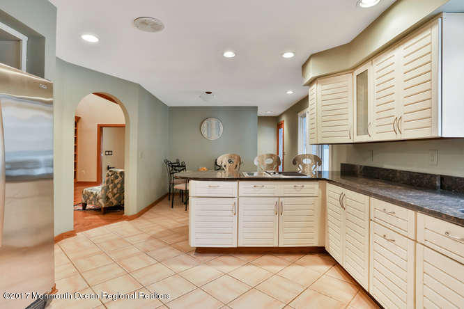 1644 Martin Road Neptune, NJ 07753 - Photo 23 of 42 a spacious bathroom with a double vanity sink a mirror and a shower