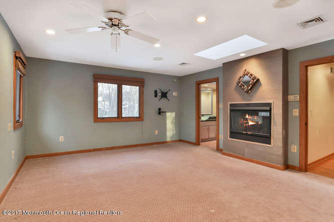 1644 Martin Road Neptune, NJ 07753 - Photo 32 of 42 a view of an empty room with a fireplace and a window