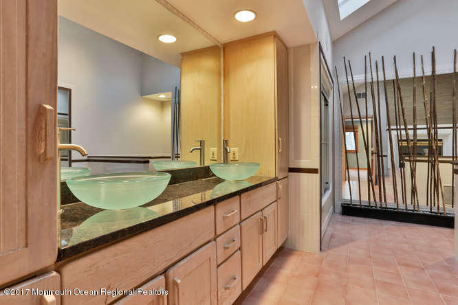 1644 Martin Road Neptune, NJ 07753 - Photo 33 of 42 a bathroom with a granite countertop sink and a mirror