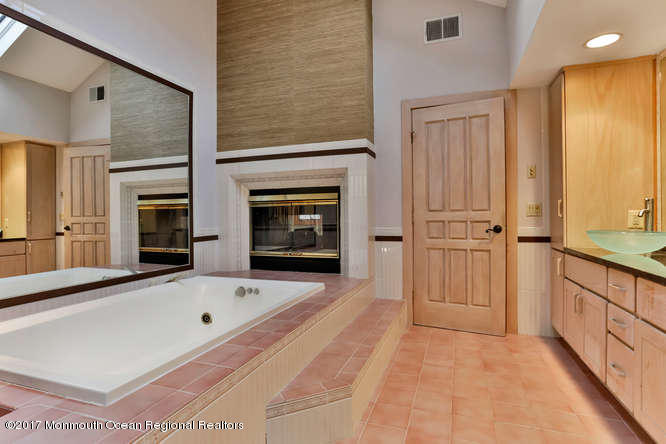 1644 Martin Road Neptune, NJ 07753 - Photo 35 of 42 a bathroom with a tub sink shower and mirror