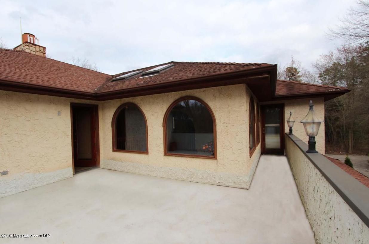 1644 Martin Road Neptune, NJ 07753 - Photo 6 of 42 a yellow house with a outdoor space