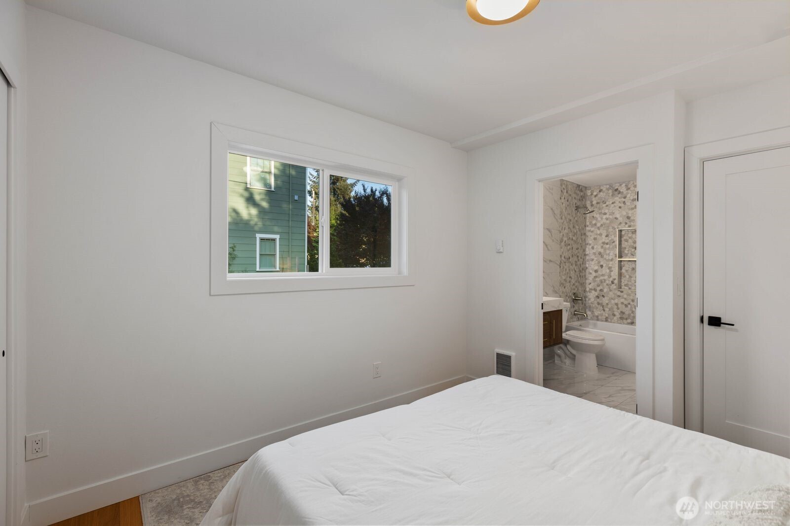 512 Northwest 44th Street Seattle, WA 98107 - Photo 15 of 37 a bedroom with a bed and a window