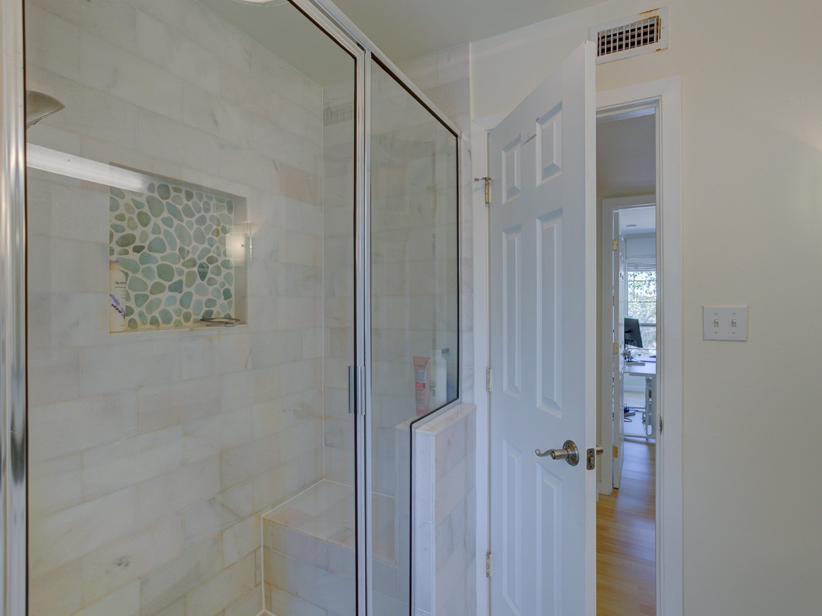 710 Castle Ridge Road, Unit B Austin, TX 78746 - Photo 24 of 27 A rejuvenating shower retreat with glass enclosure and mosaic tile accents.