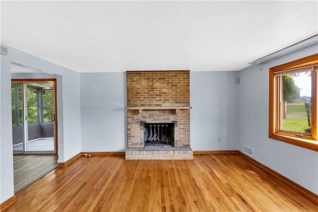 51 Revo Road Pittsburgh, PA 15236 - Photo 5 of 38 A handsome neutral brick fireplace instantly sets a cozy tone in the living room.