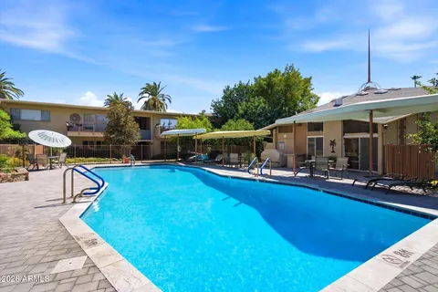 a view of a patio with swimming pool table and chairs
