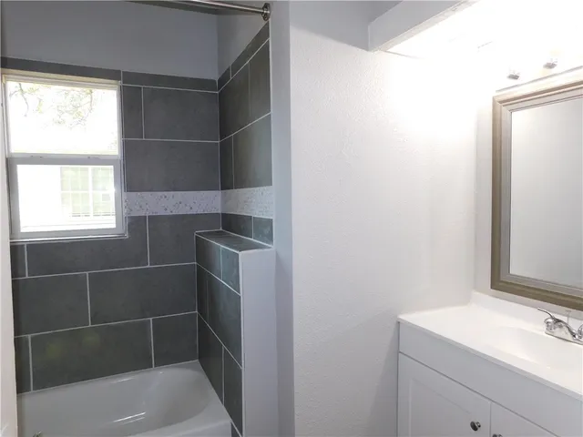 a bathroom with a bathtub and a sink