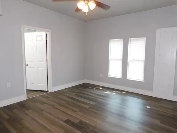wooden floor in an empty room with a window