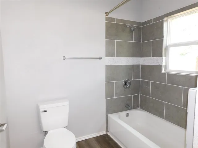 a bathroom with a toilet and bathtub