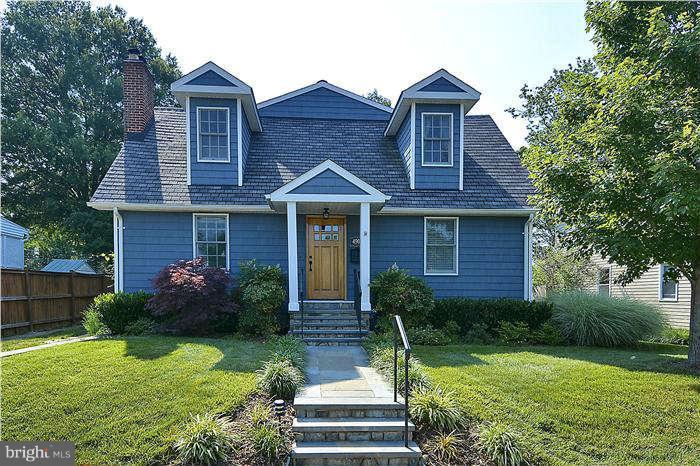4904 South Chesterfield Road Arlington, VA 22206 - Photo 1 of 30 a front view of a house with a yard and garage