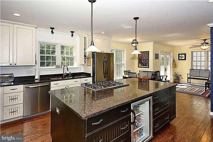 4904 South Chesterfield Road Arlington, VA 22206 - Photo 15 of 30 a kitchen with stainless steel appliances granite countertop a sink a stove and a wooden floors