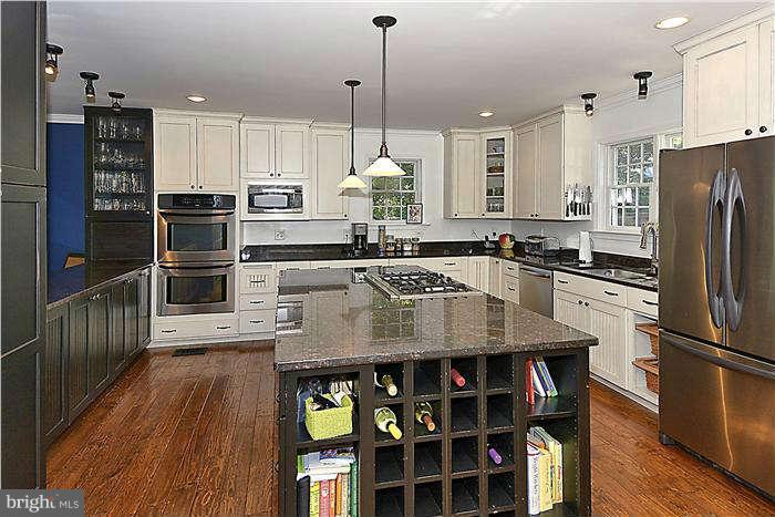 4904 South Chesterfield Road Arlington, VA 22206 - Photo 17 of 30 a kitchen with stainless steel appliances granite countertop a sink refrigerator and cabinets