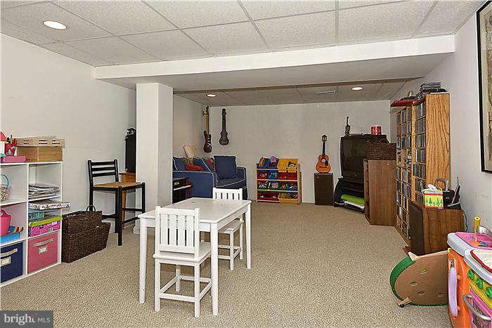 4904 South Chesterfield Road Arlington, VA 22206 - Photo 28 of 30 a room with furniture a chandelier and a projector