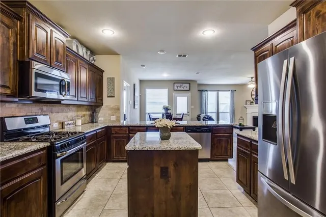 a kitchen with a refrigerator sink and microwave