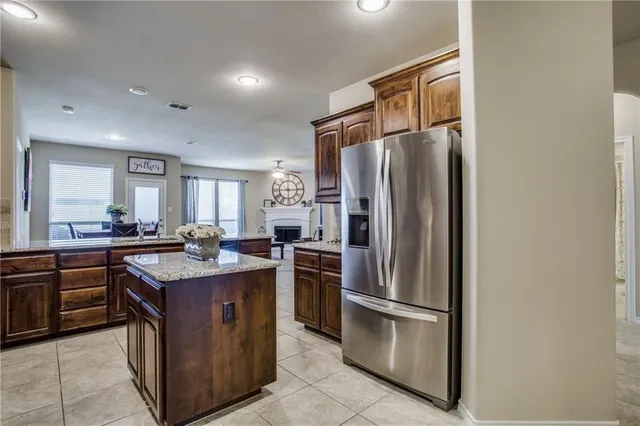 a kitchen with stainless steel appliances granite countertop a stove a refrigerator and a sink