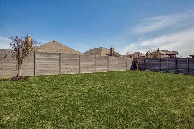 a view of a backyard with a garden and entertaining space